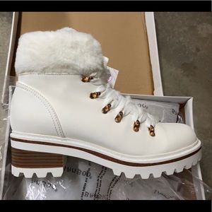 White fur boots with fur by the ankles.